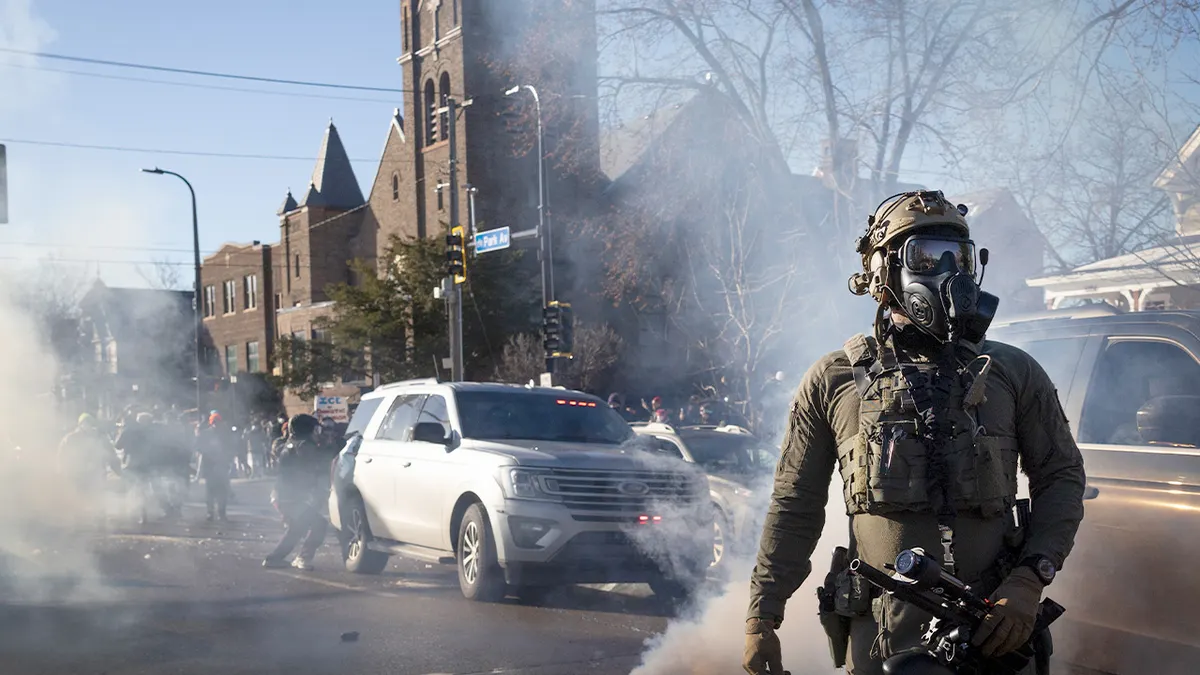 Federal immigration agents tossing tear gas during a house raid in Minneapolis Minnesota