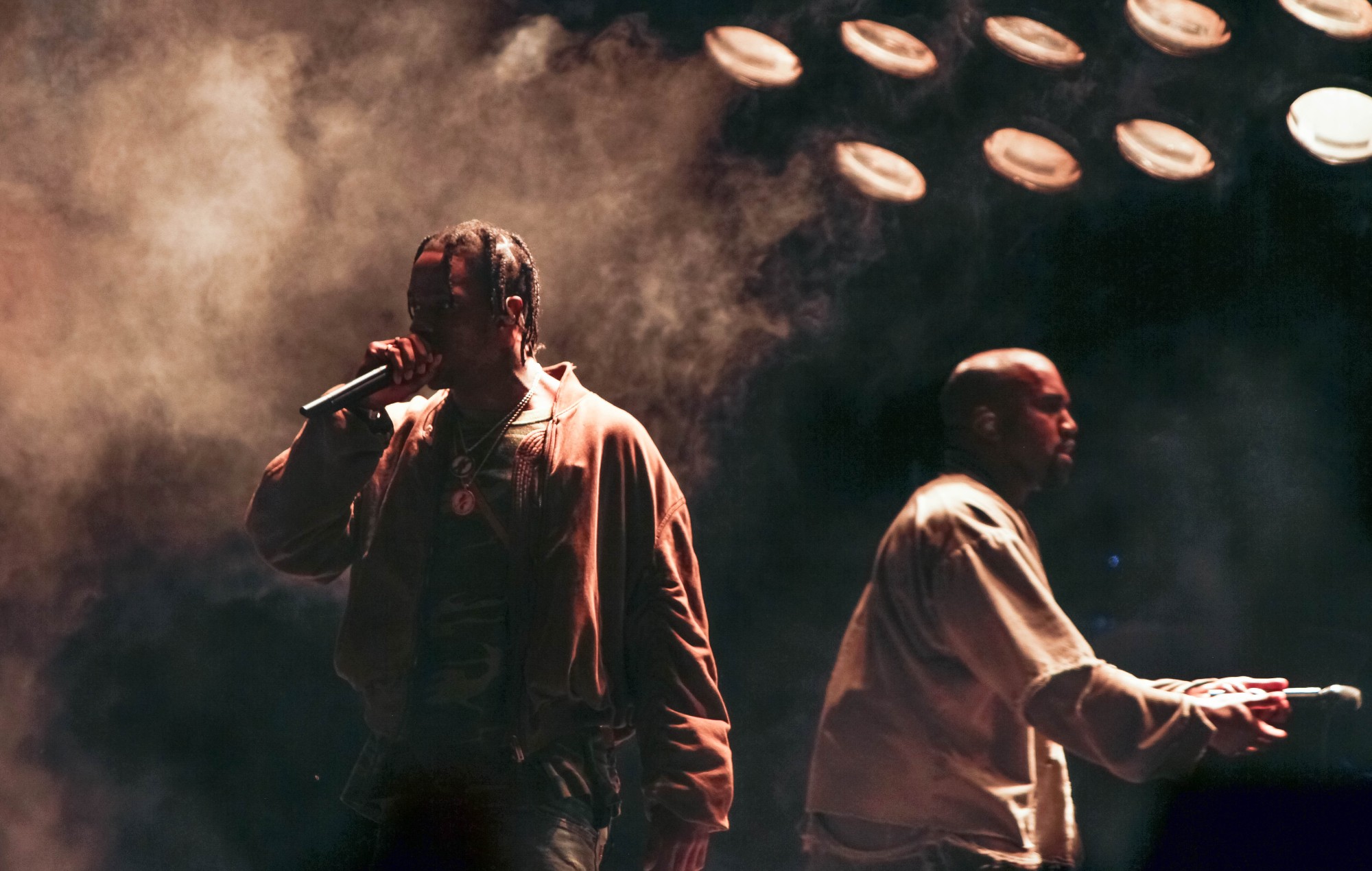 Travis Scott performs with Kanye West, 2015. CREDIT: Brian Gove/WireImage