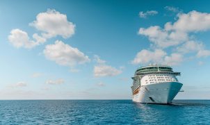 white and blue ship on sea under blue sky and white clouds during daytime