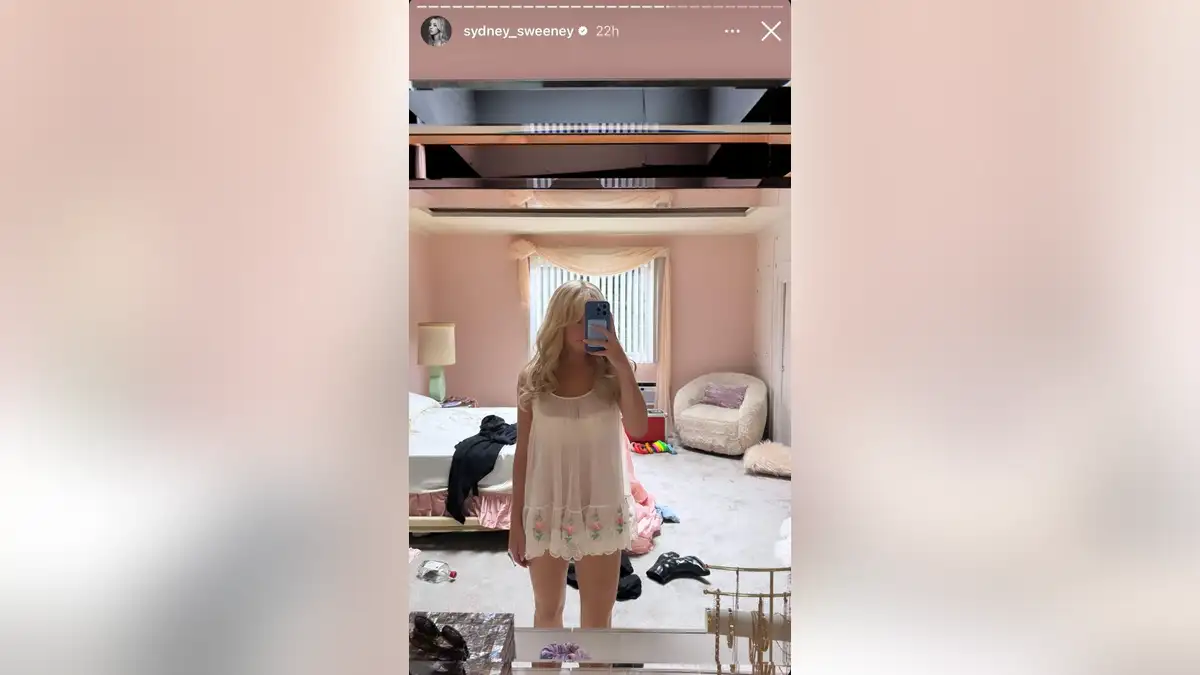 A mirror selfie of Sydney Sweeney in white negligee