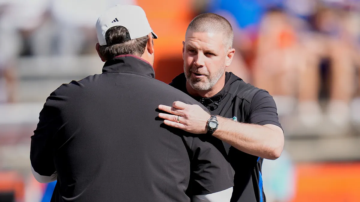 Mississippi State head coach Jeff Lebby and Florida head coach Billy Napier greeting each other on football field