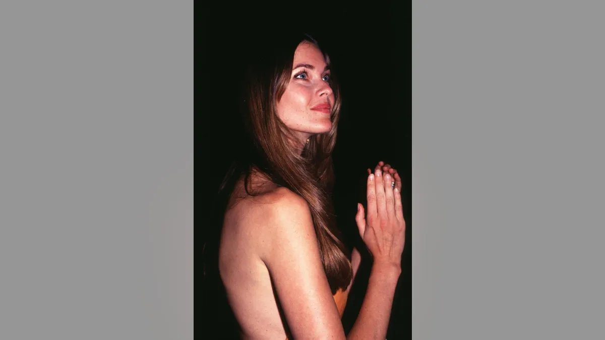 Carol Alt posing with hands in prayer pose at Club USA in New York City