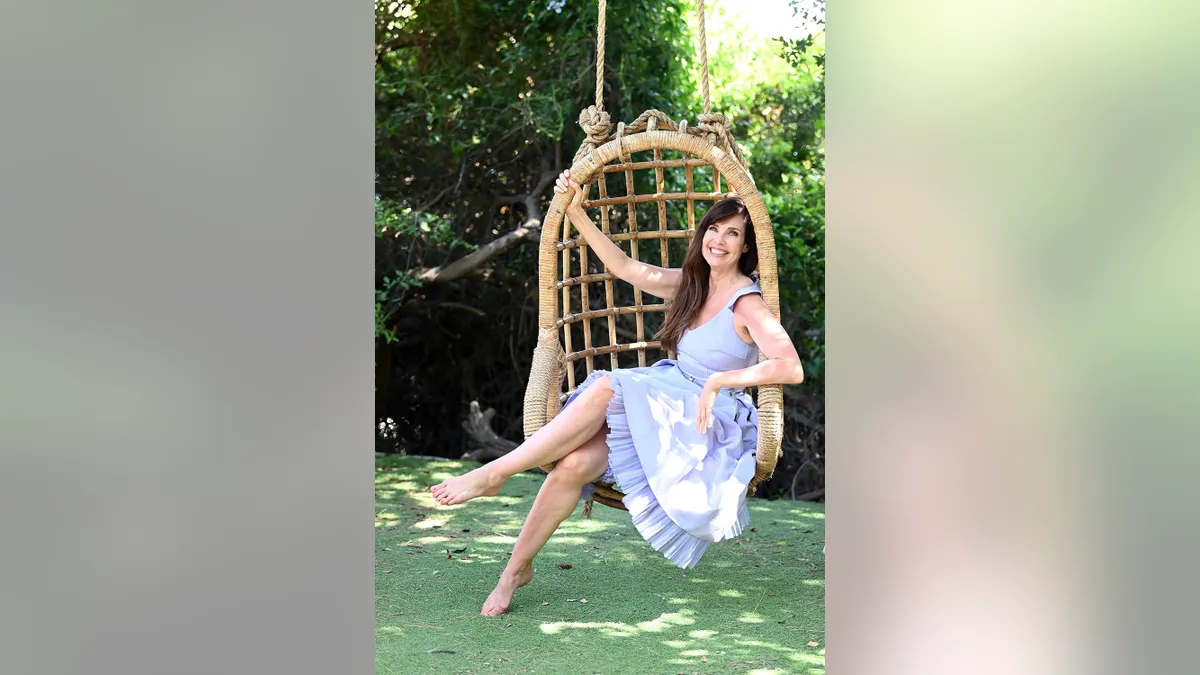 Carol Alt wearing a light blue sundress at a press conference in Santa Margherita di Pula Italy