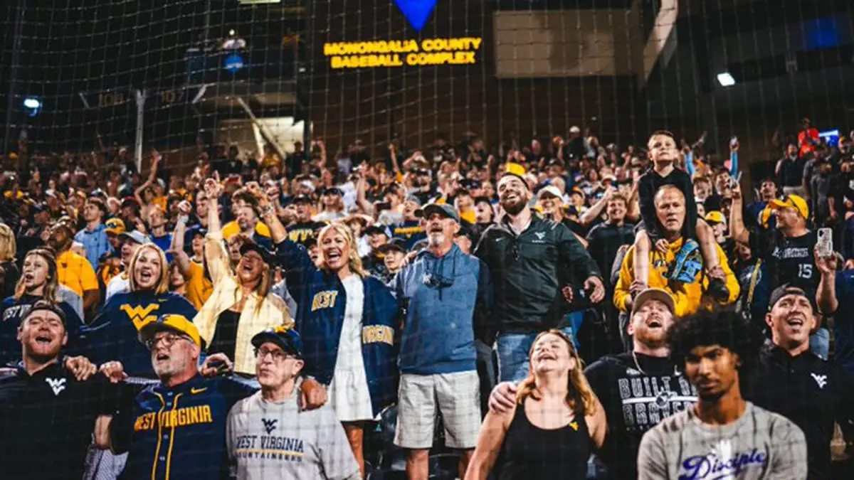 West Virginia fans celebrate the Mountaineers defeating Kentucky for a spot in the NCAA Tournament Super Regional