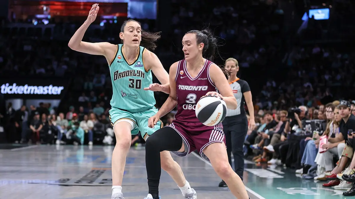 Marina Mabrey driving past Breanna Stewart during basketball game at Barclays Center