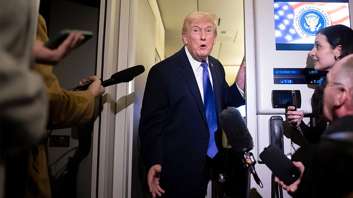 President Donald Trump speaking to media aboard Air Force One
