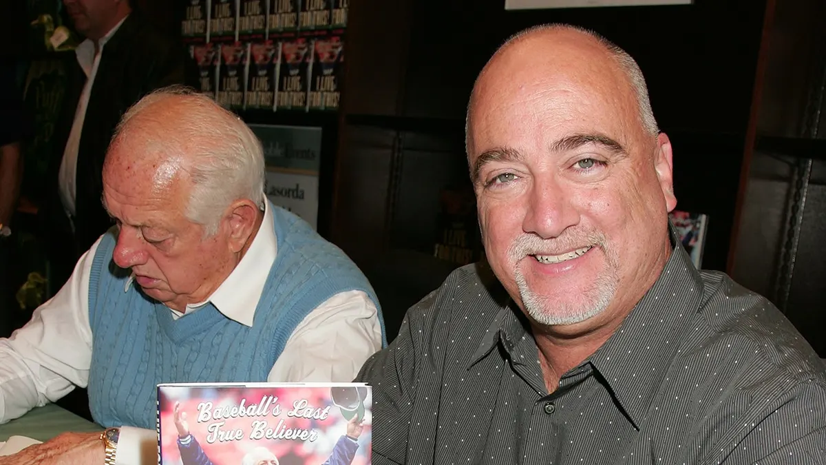 Baseball great Tommy Lasorda and sports columnist Bill Plaschke at a book signing event.
