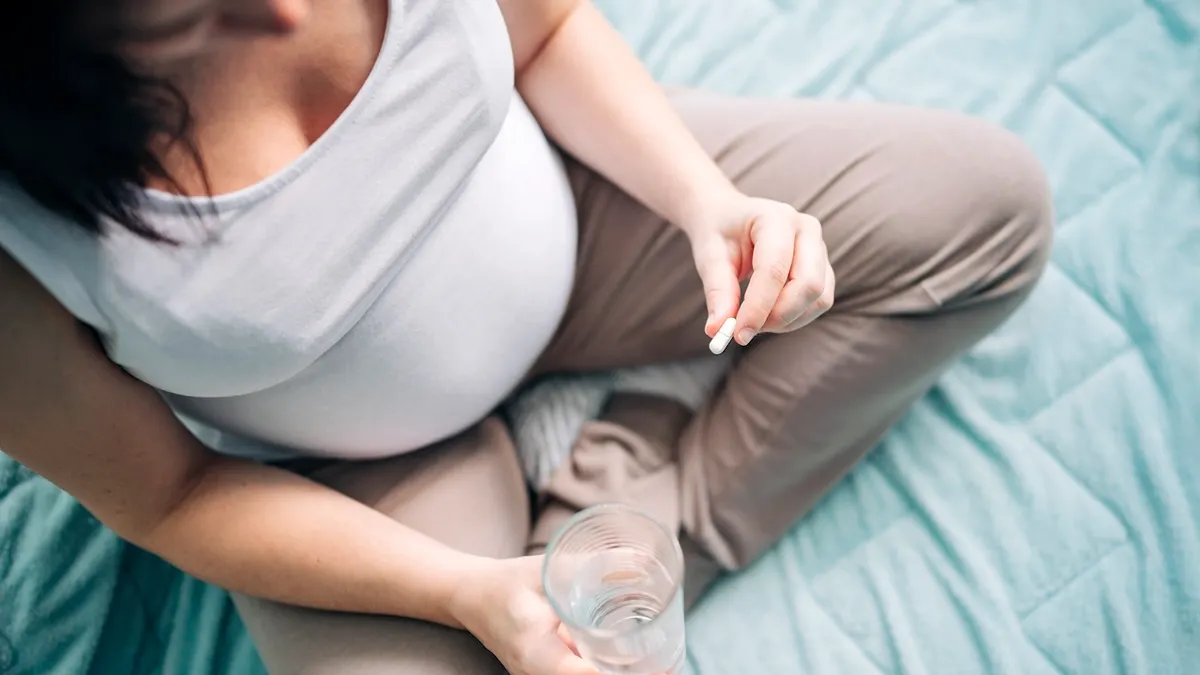 Pregnant woman taking pills