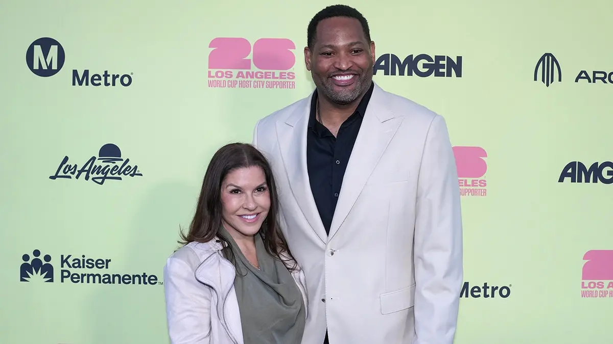 Robert Horry and Candice Horry posing on the blue carpet at the World Cup 2026 Kickoff Party