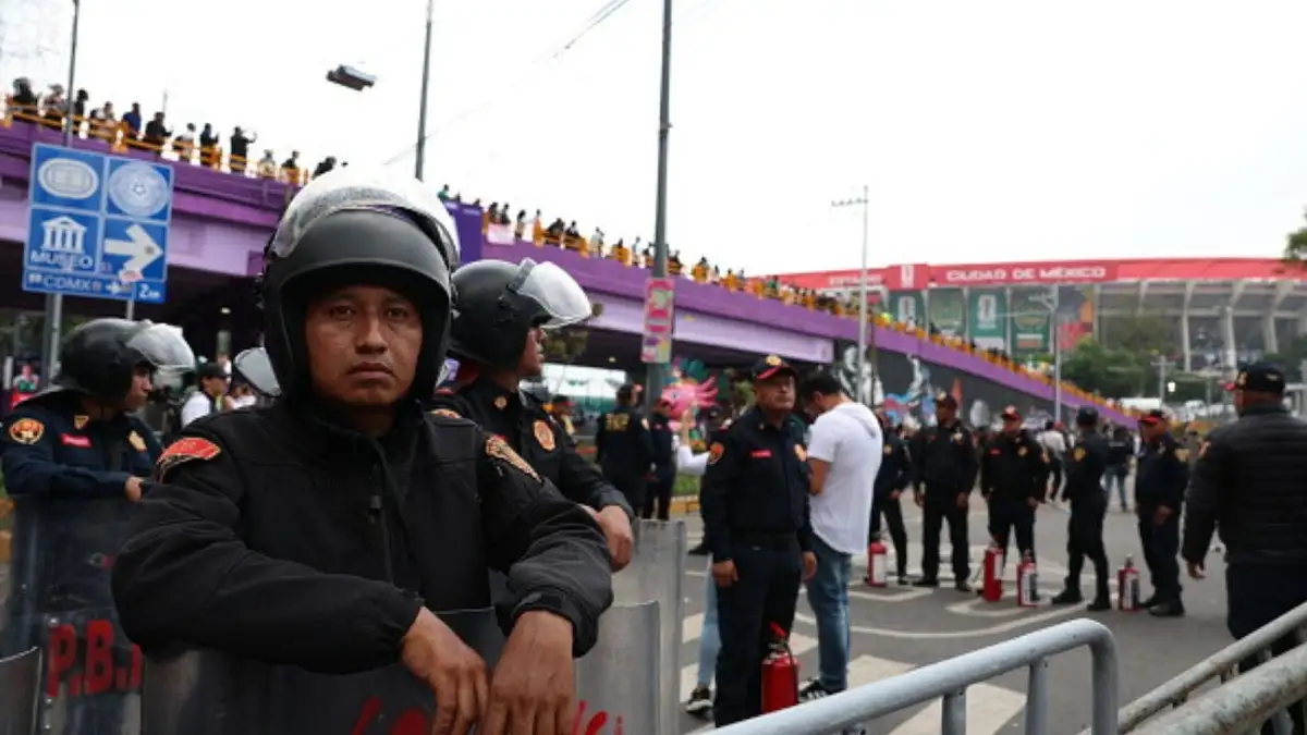 Police stand guard outside Estadio Azteca as anti-government protesters gather on World Cup opening day. (Photo by Claudia Rosel/Getty Images)