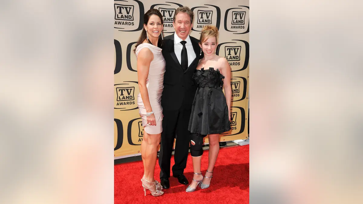 Actor Tim Allen standing with actress Jane Hajduk and daughter Katherine Allen at an event.