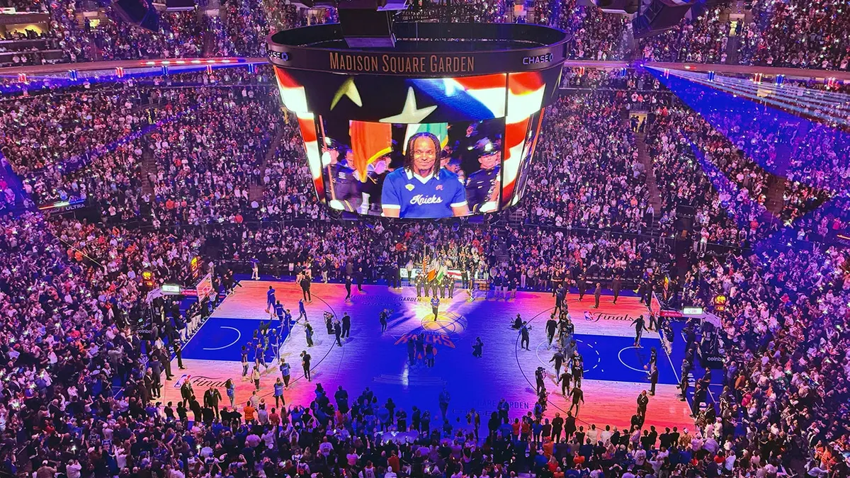 New York Knicks fans standing and watching the National Anthem at Madison Square Garden.
