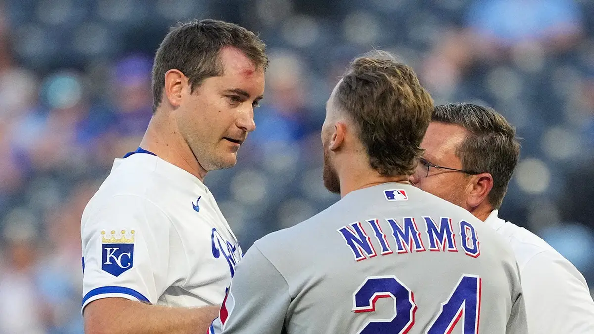 Texas Rangers right fielder Brandon Nimmo talks with Kansas City Royals starting pitcher Seth Lugo at Kauffman Stadium.