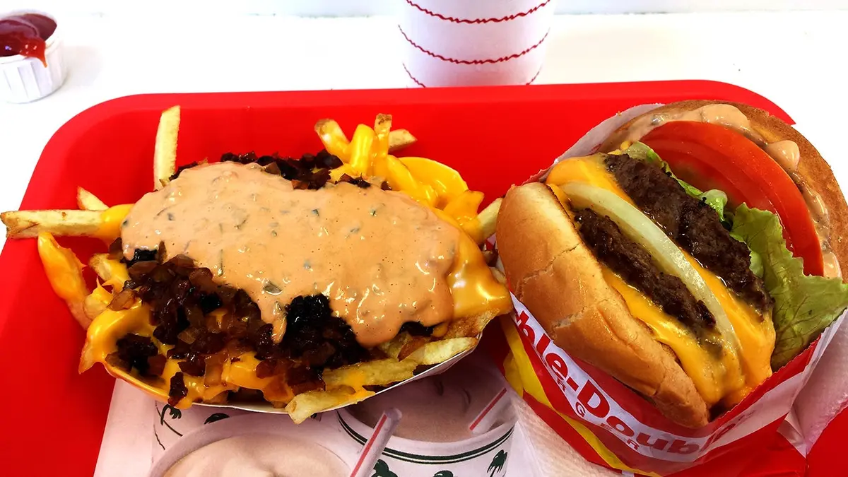 Two In-N-Out burgers with fries sit on a tray.
