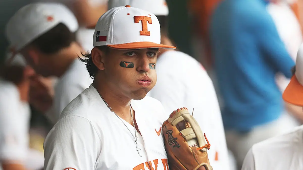 Infielder Adrian Rodriguez wearing Texas Longhorns uniform sitting in dugout.