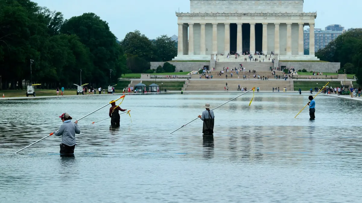 National Park Service employees in the Lincoln Memorial Reflecting Pool