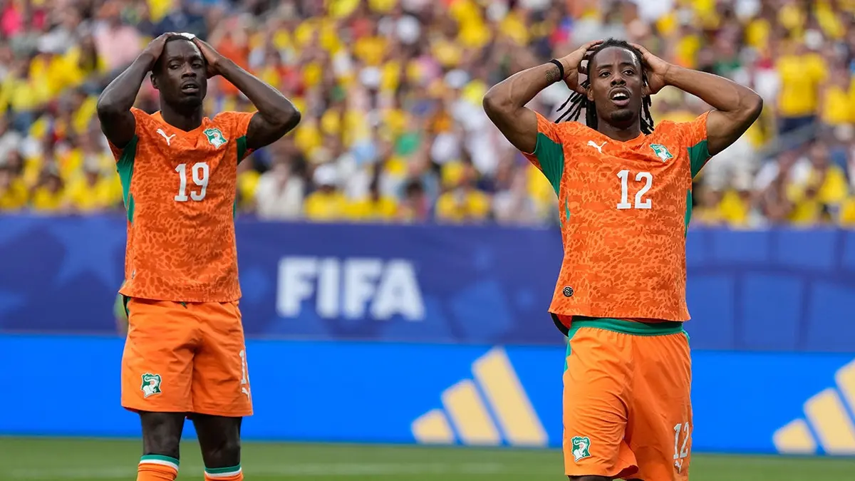 Ivory Coast's Elye Wahi and Nicolas Pepe reacting after missing a scoring chance in a soccer match.