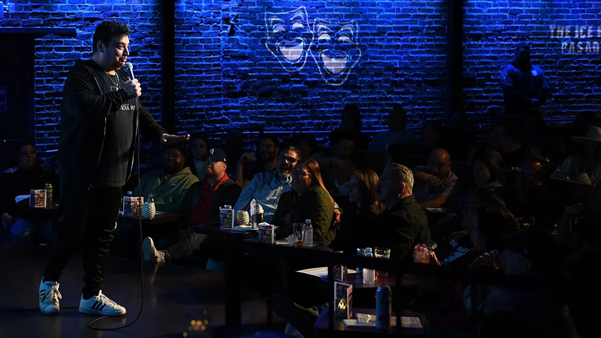 Comedian Carlos Mencia performing on stage at The Ice House Comedy Club in Pasadena, California.