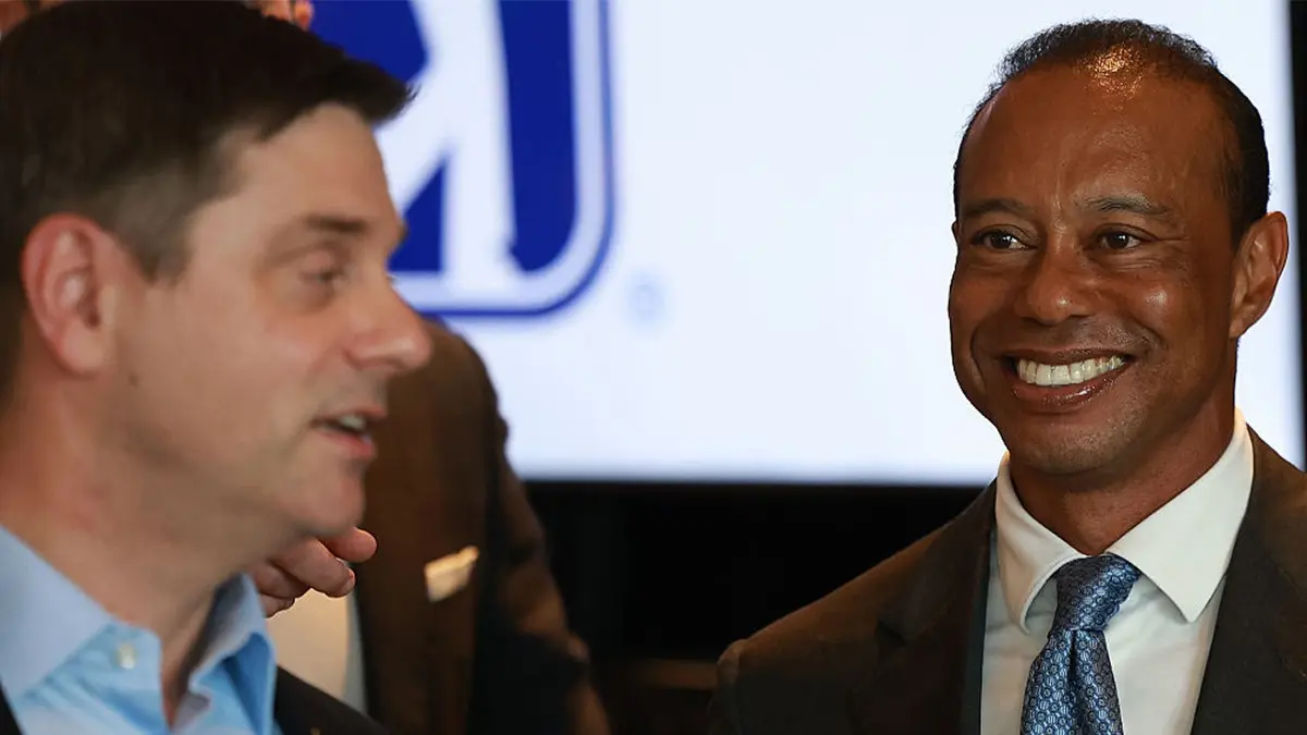 Tiger Woods of the United States looks towards Brian Rolapp