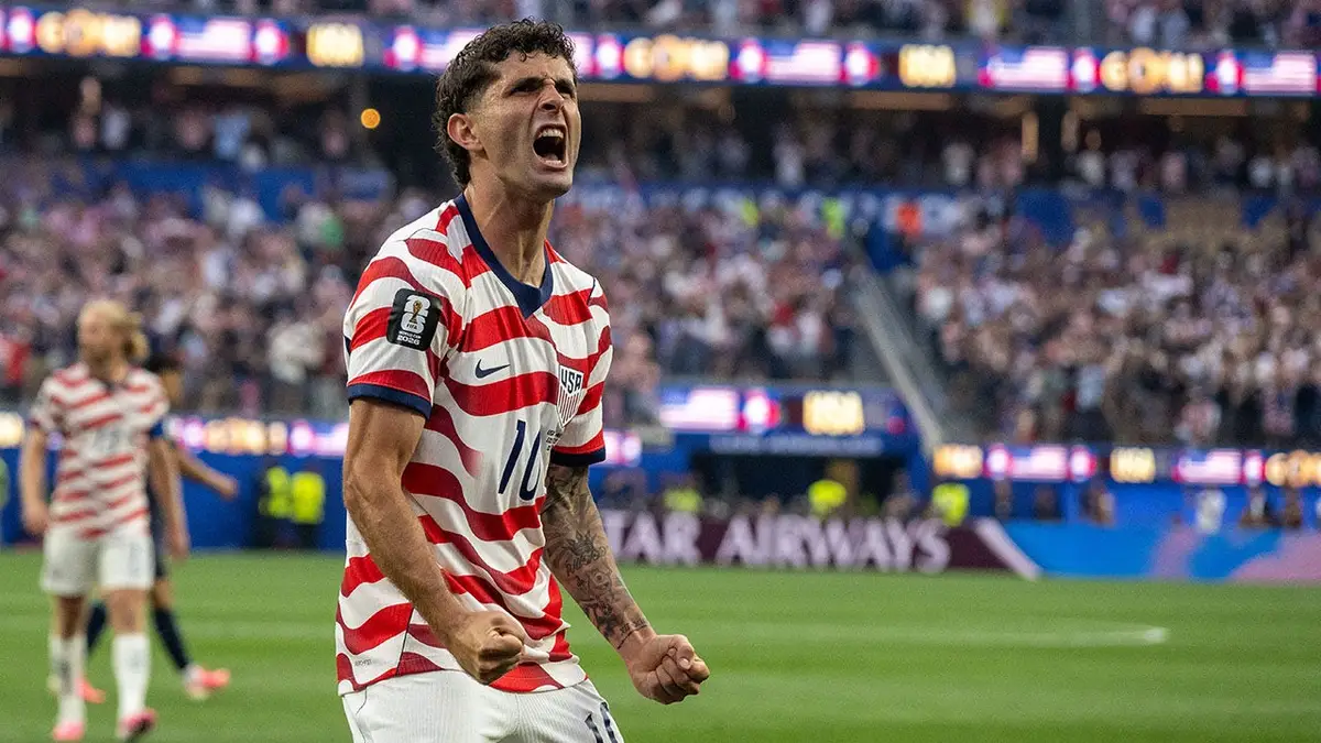 Christian Pulisic celebrates after a goal during a soccer match at Los Angeles Stadium.
