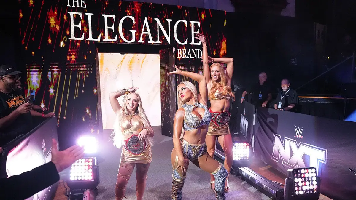 Ash By Elegance accompanied by Heather Reckless and M By Elegance walking to the ring at Lowell Memorial Auditorium.
