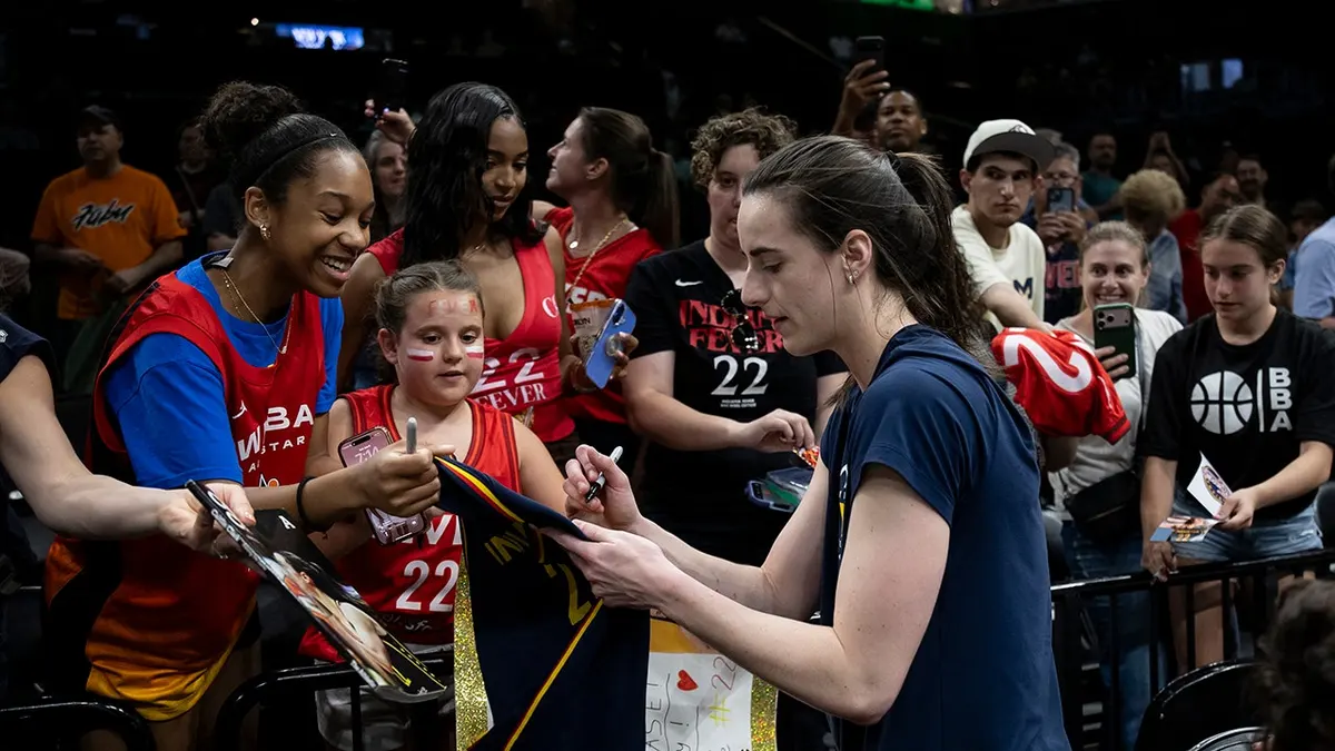 Caitlin Clark signing autographs for fans at Barclays Center in New York City