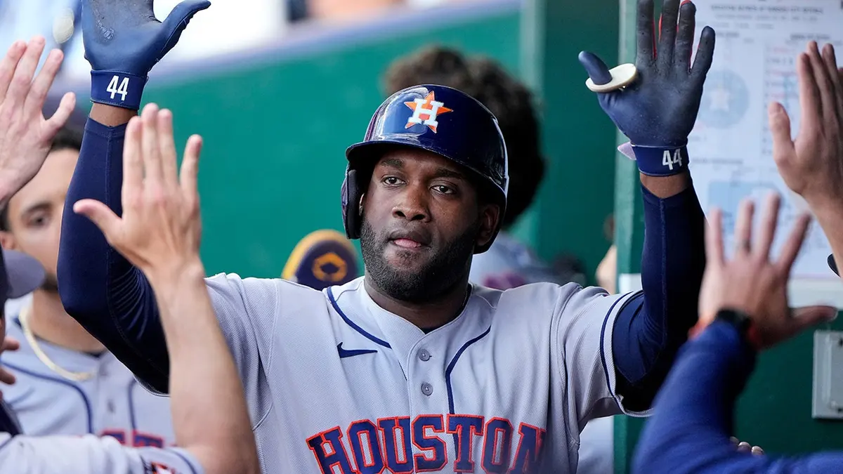 Houston Astros' Yordan Alvarez celebrating in the dugout