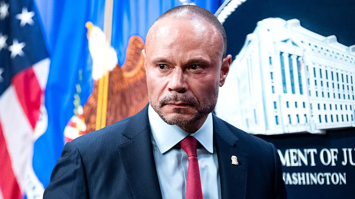 FBI Deputy Director Dan Bongino standing at a podium during a news conference