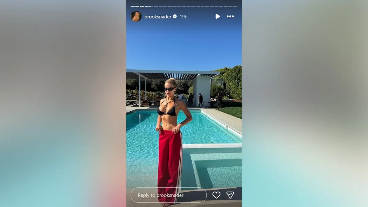 Brooks Nader in a bikini next to a swimming pool.