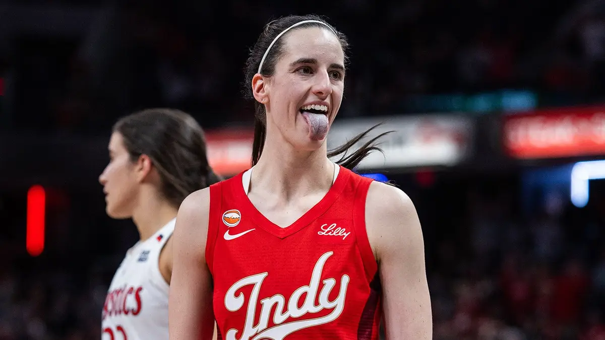 Indiana Fever guard Caitlin Clark celebrating a made shot on basketball court