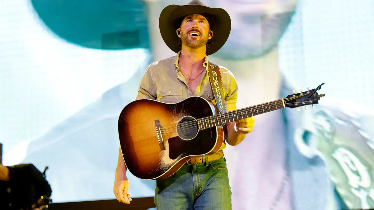 Riley Green performing onstage at Bridgestone Arena in Nashville, Tennessee