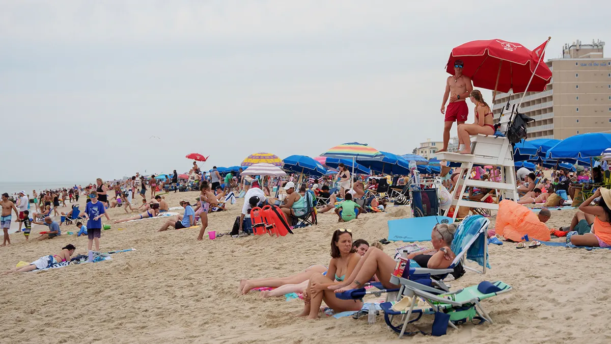 People relaxing on Rehoboth Beach in Delaware under a heat advisory