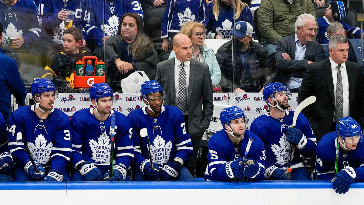 Spencer Carbery assistant coach of the Toronto Maple Leafs looking on from the bench during a game.