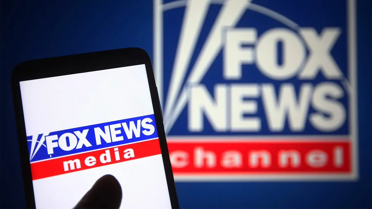 Fox News logo on phone and on a sign