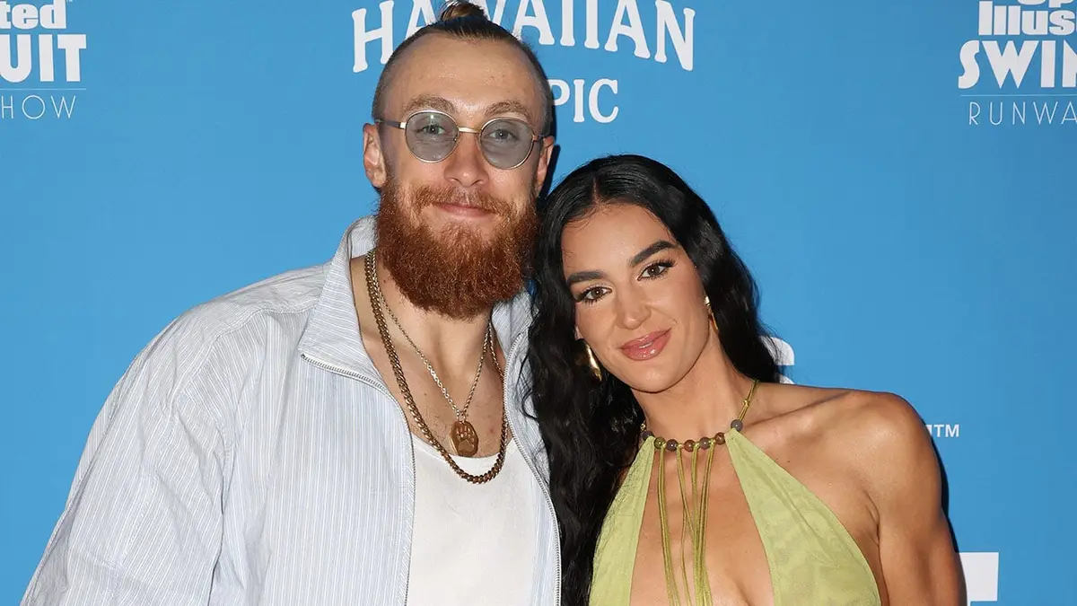 George Kittle and Claire Kittle standing together at Sports Illustrated Swimsuit Runway Show in Miami Beach