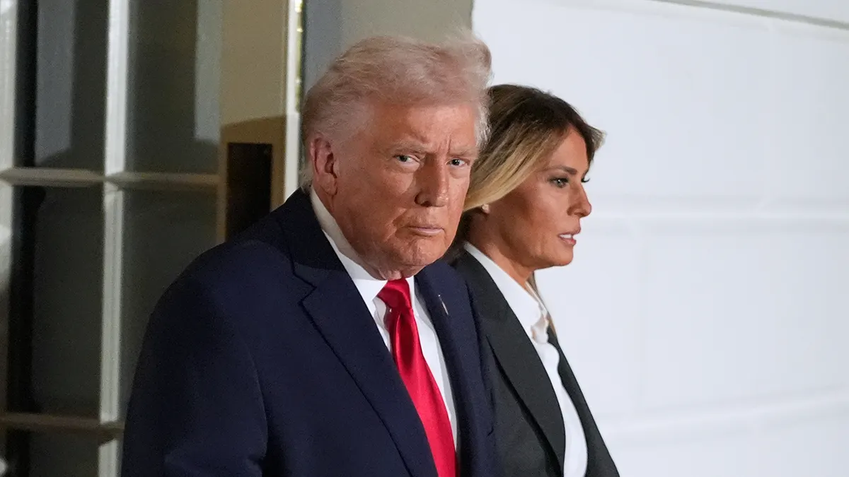 Donald Trump and Melania Trump walking out of the White House in Washington.