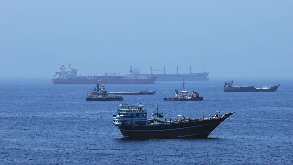 Commercial cargo vessels and crude oil tankers anchored in the Gulf of Oman near Muscat