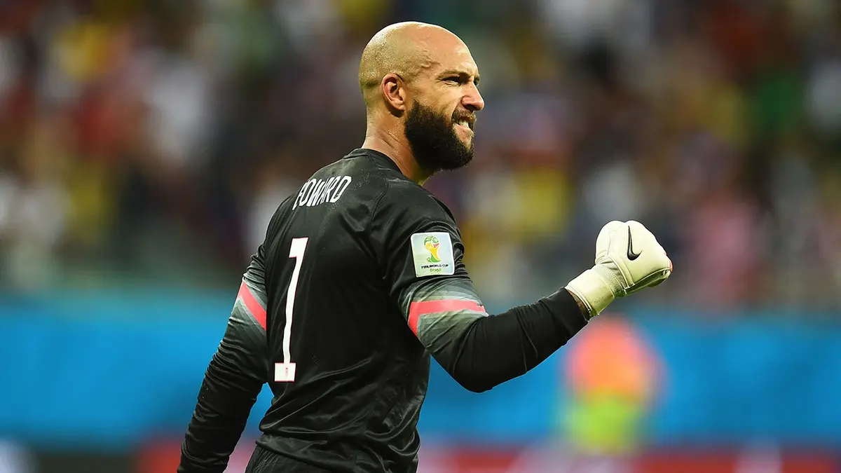 Tim Howard diving to save a ball during a soccer match at Arena Fonte Nova in Salvador, Brazil