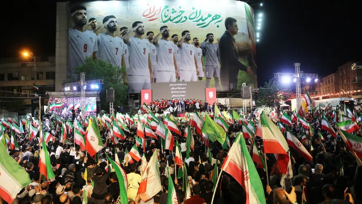 Iranian football supporters gathering at Enghelab Square in Tehran during a ceremony