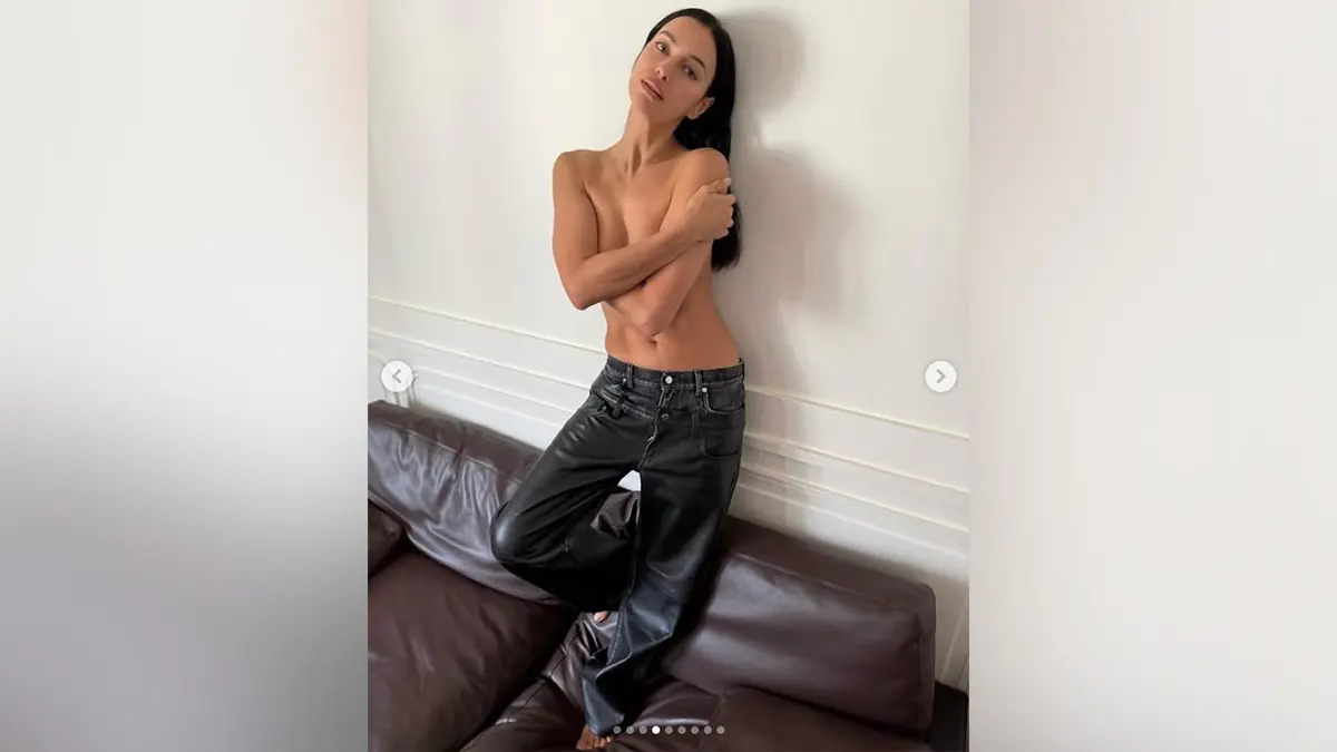 Irina Shayk posing topless while in black pants on Instagram in June 2026.