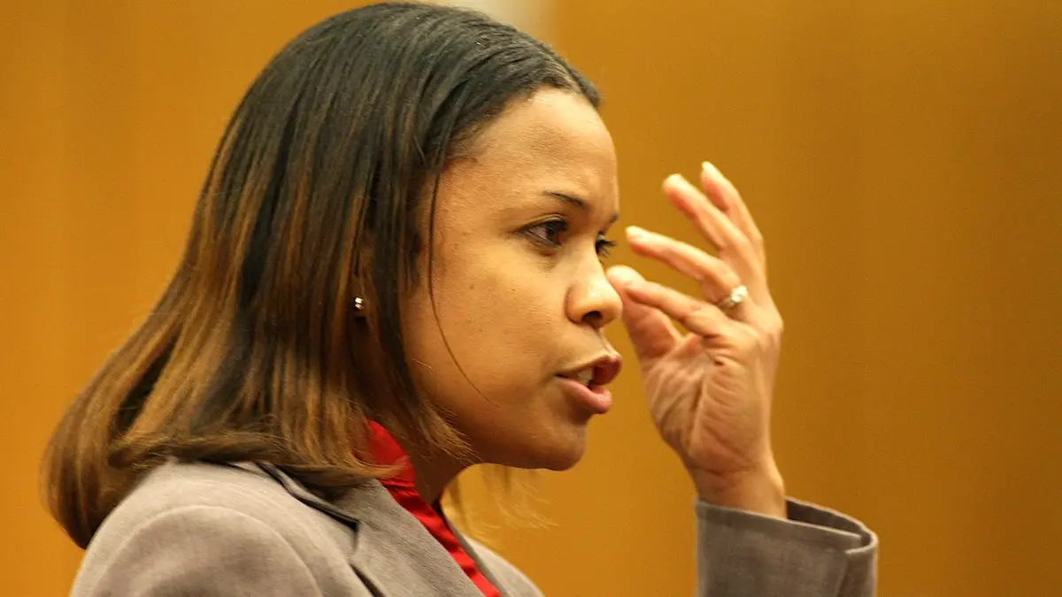 judge eleanor ross brushes her hair out of her face during testimony