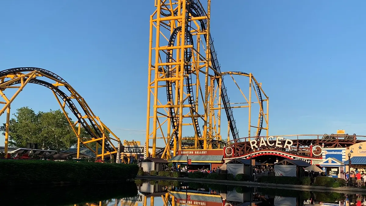 Kennywood park roller coaster reflected on water surface.