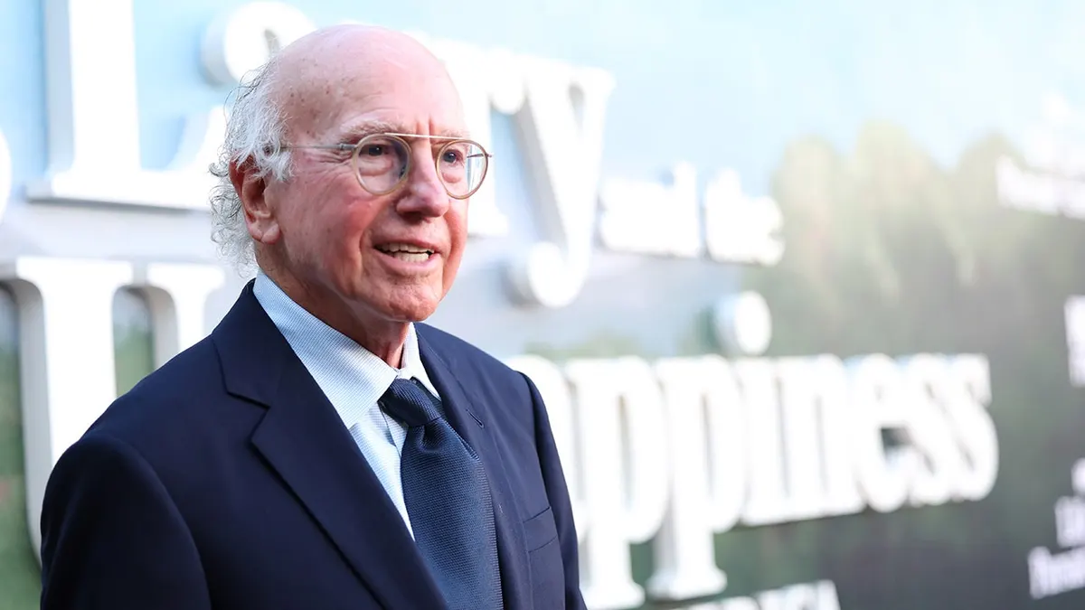 Larry David standing on the red carpet at the Hollywood Legion Theater in Los Angeles