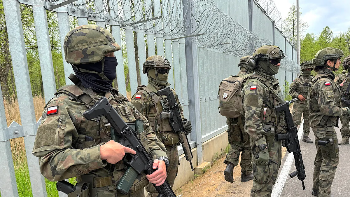 Polish soldiers standing watch near the Belarus border.