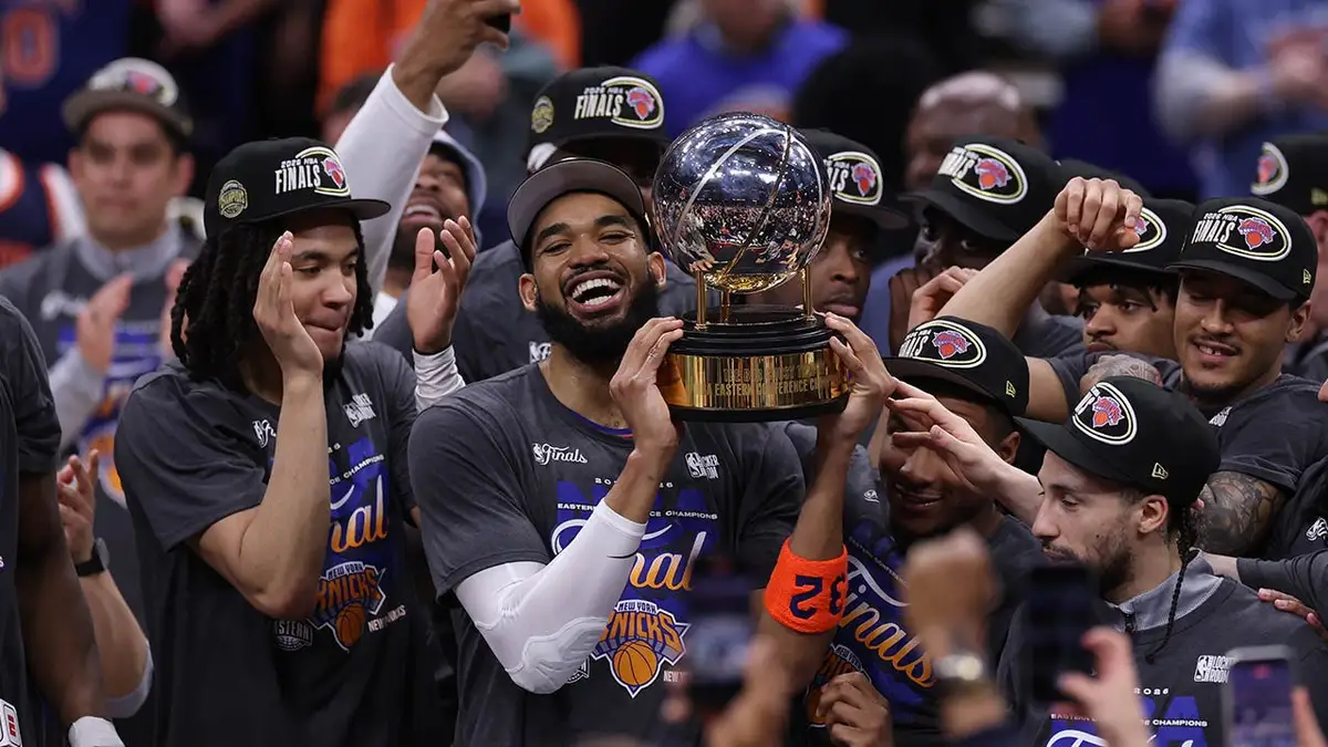 New York Knicks center Karl-Anthony Towns celebrating with teammates on basketball court