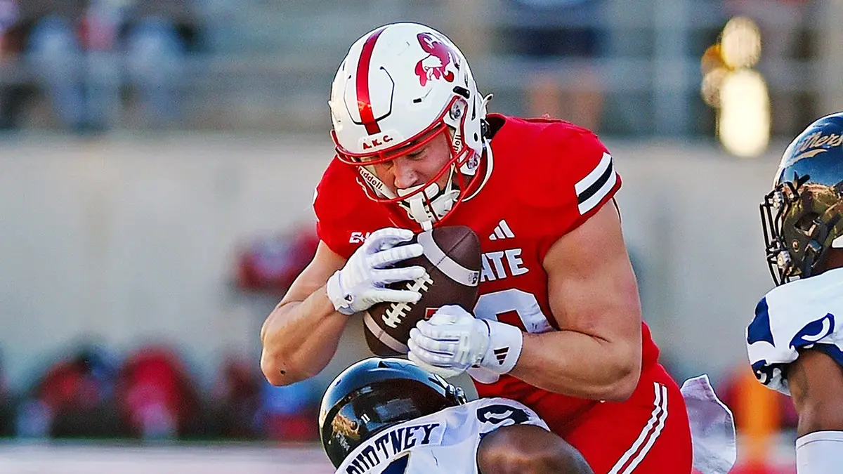 Jacksonville State's Brock Rechsteiner tries to evade the tackle of FIU's Percy Courtney Jr. on the football field