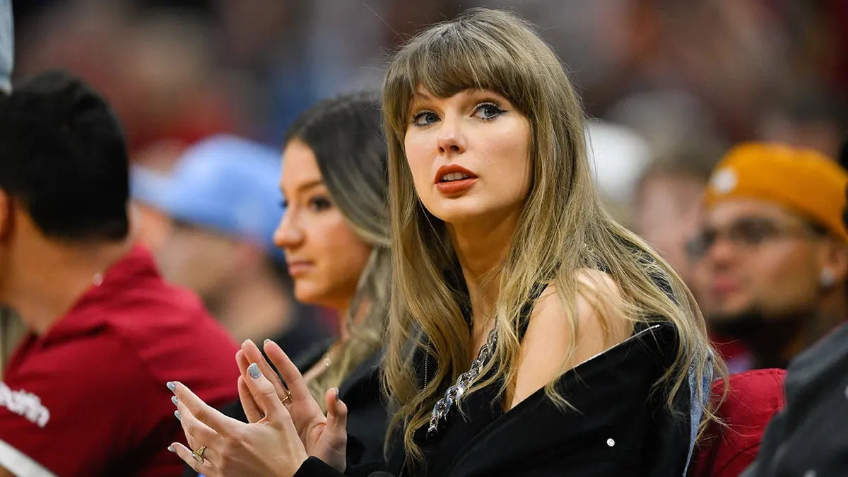 Taylor Swift standing courtside during NBA Eastern Conference Finals game in Cleveland