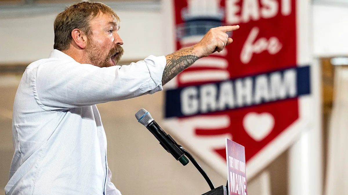 graham platner exults and points during a primary victory speech