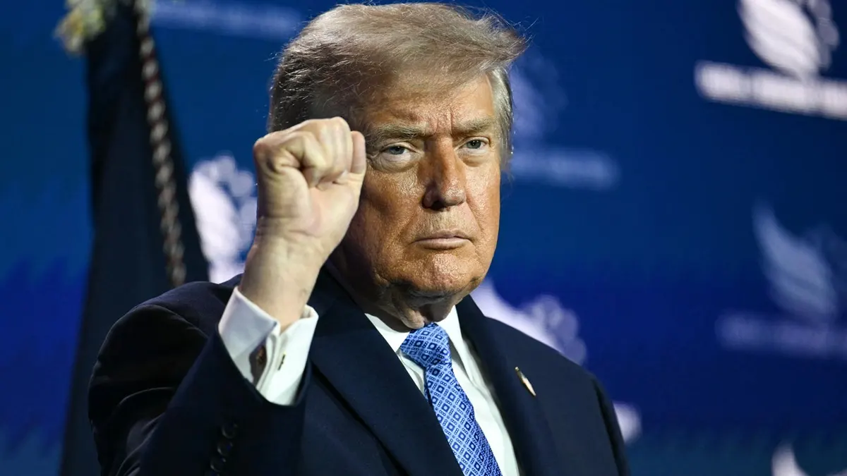 trump pumps fist in air at Faith & Freedom Coalition