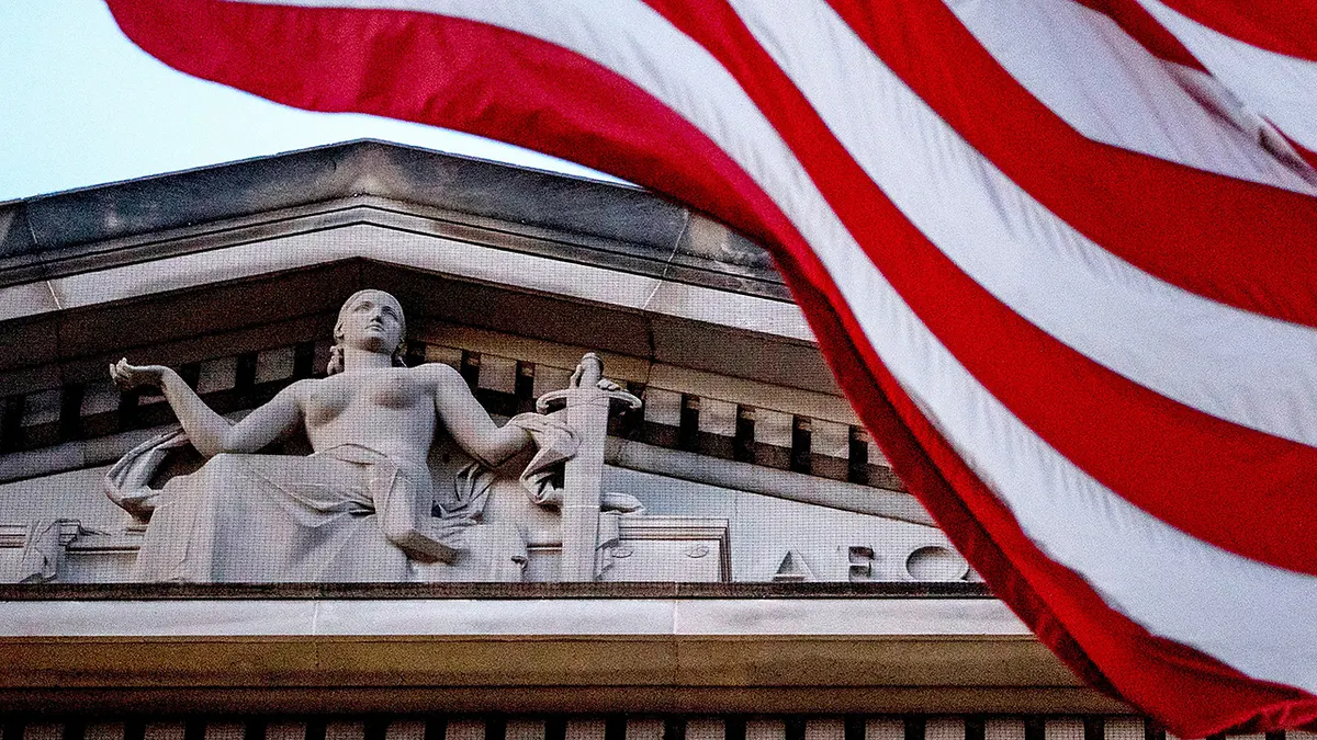 FILE - An American flag flies outside the Department of Justice in Washington, March 22, 2019.